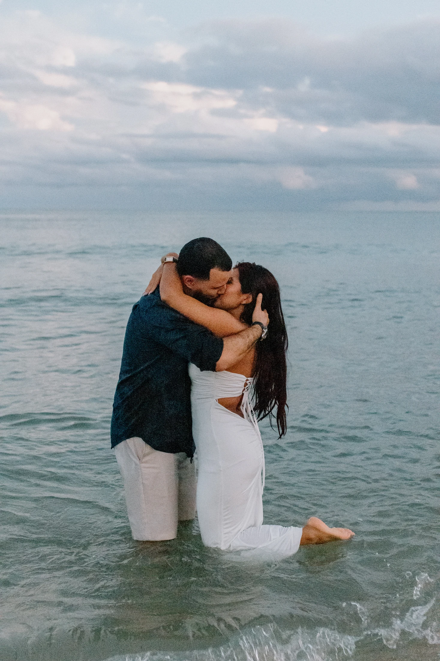 Ginna and Francisco kissing by the water
