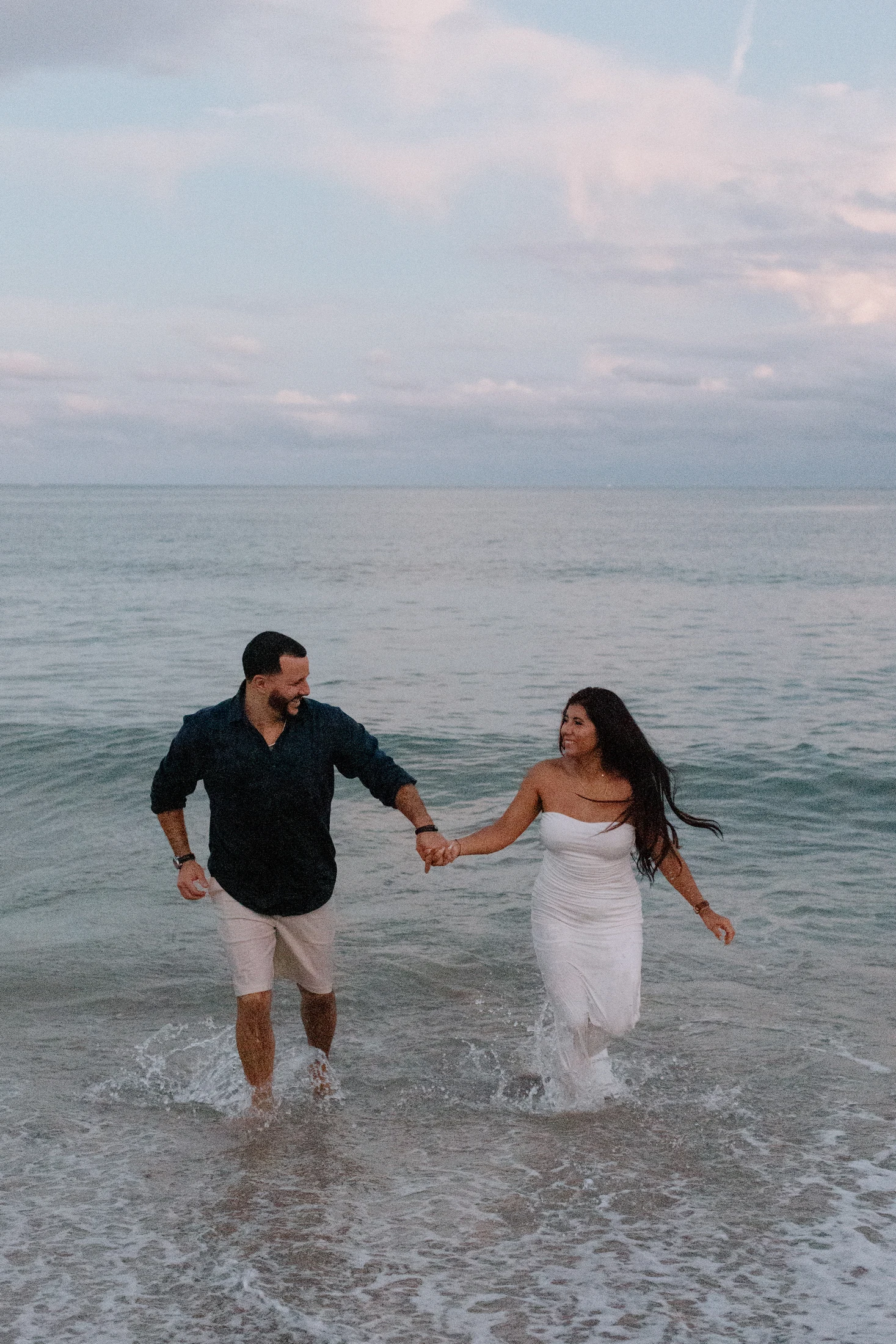 Ginna and Francisco running through the water